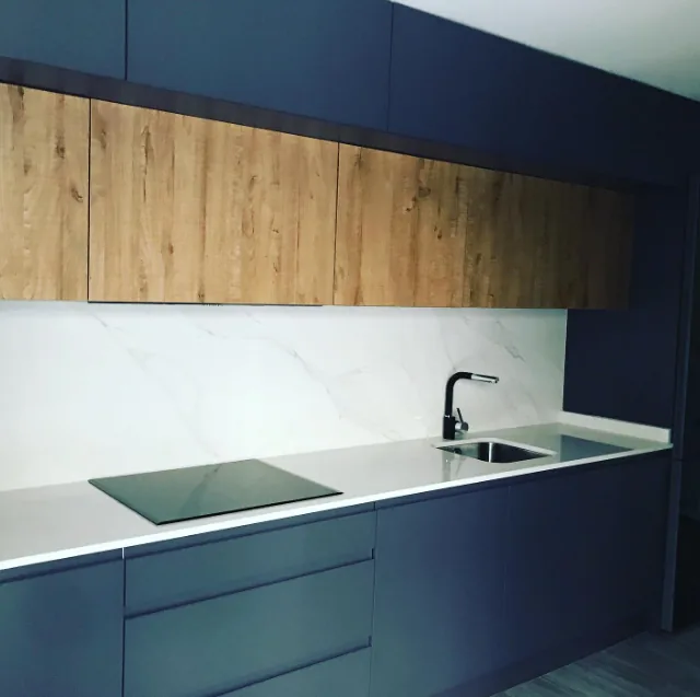 Cocina de diseño con acabado azul oscuro y madera natural